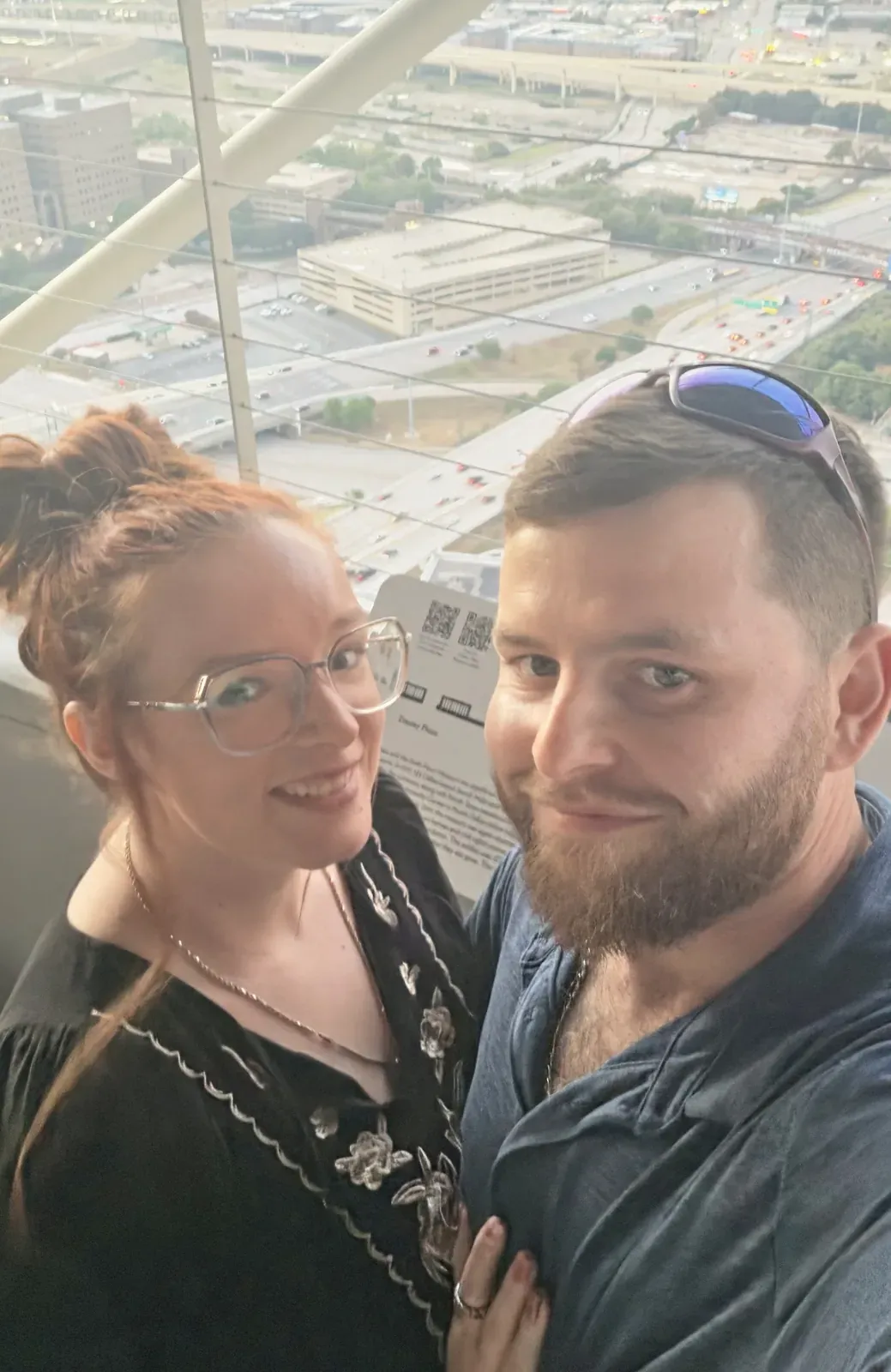 Brandon and Christina, the husband-and-wife owners of Booty Scoopy, with the Dallas skyline behind them