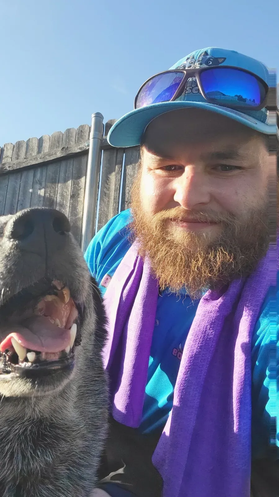 Brandon taking a selfie with a happy blue heeler on a sunny day