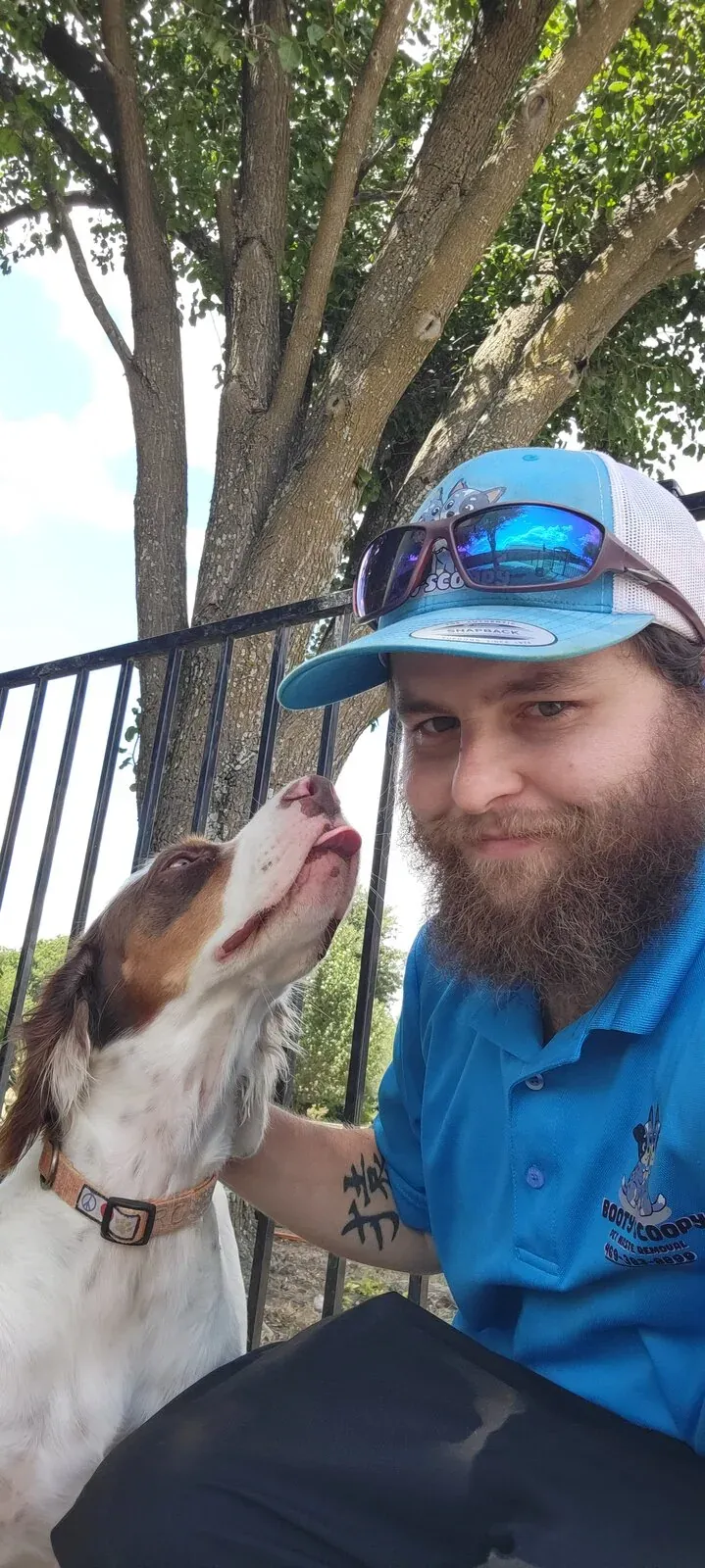 Brandon with a customer's spaniel at an iron fence