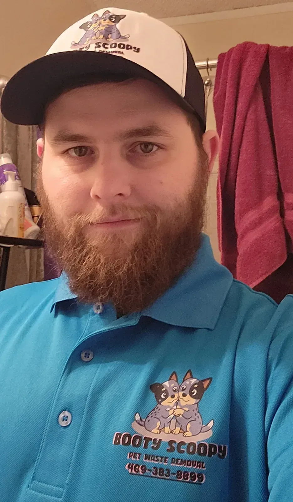 Brandon, co-owner of Booty Scoopy, in his Booty Scoopy cap and polo