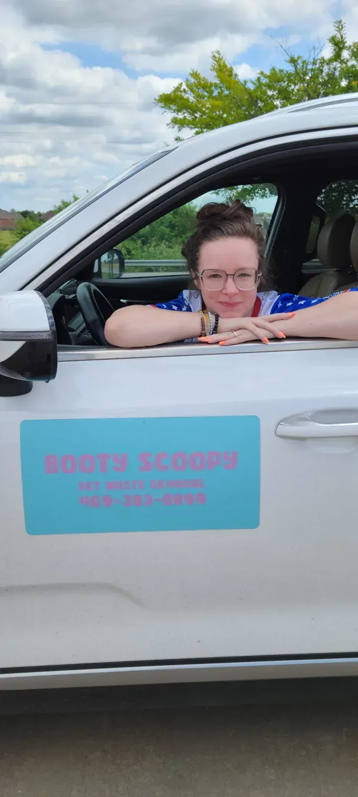 Christina in the Booty Scoopy SUV with its door sign