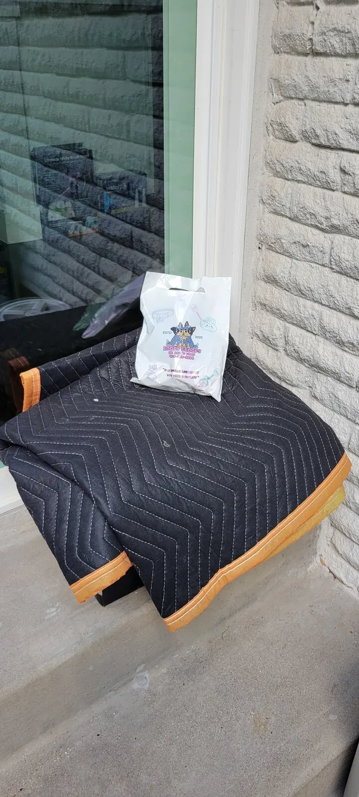 A Booty Scoopy treat bag left by a customer's door